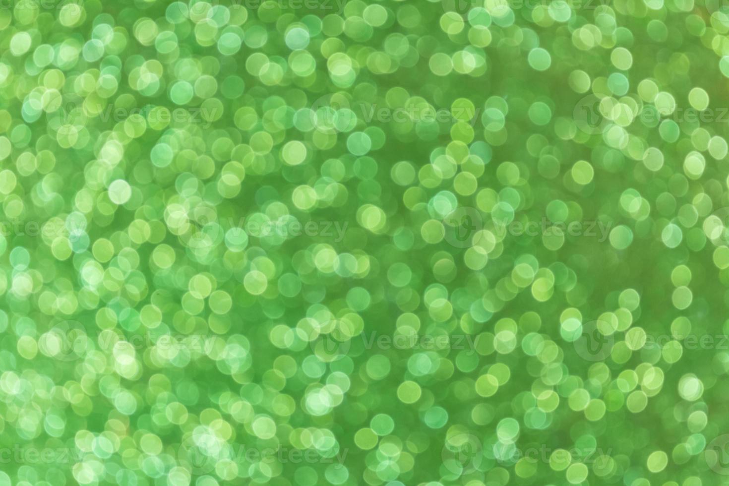 Green abstract blured background with shimmer, glitter and shine. Defocused. Summer, spring, Merry Christmas or new year bokeh. Copy space photo
