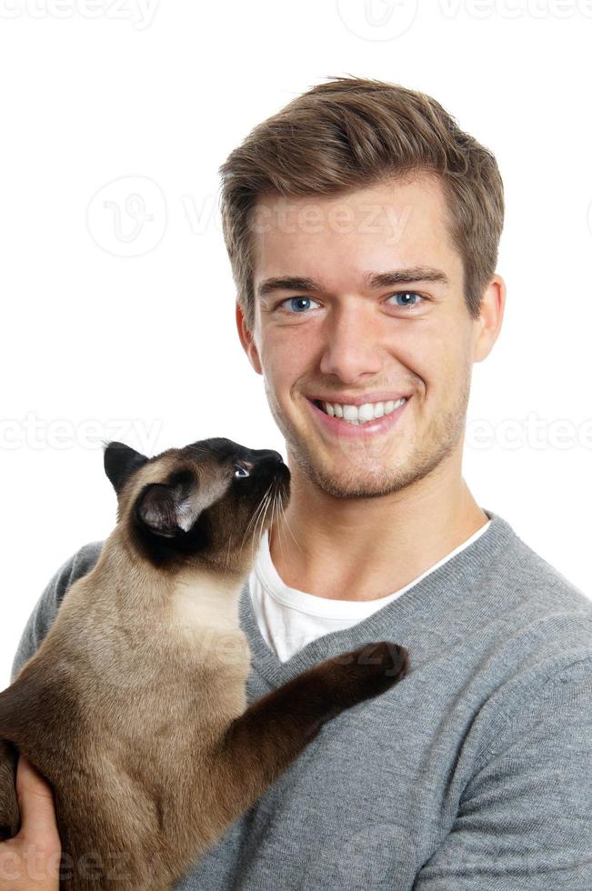 young man with siamese cat photo