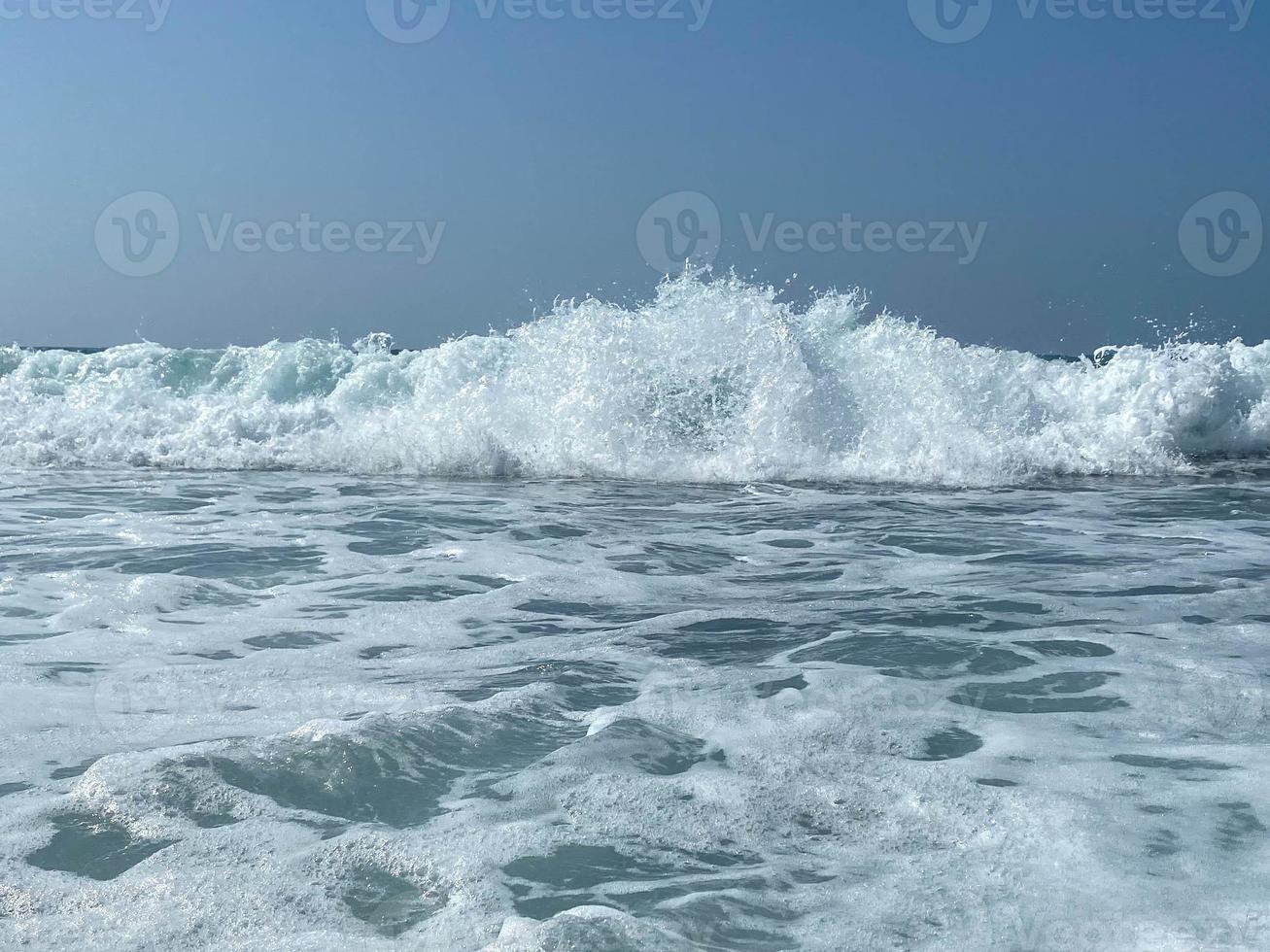 Beautiful sea with waves splashing warm sparkling clear blue water in a warm tropical oriental country southern resort. Background, texture photo