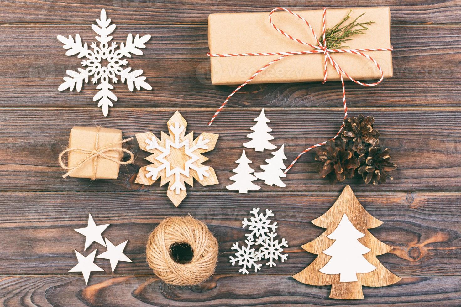 Christmas composition. Gift, christmas decoration, snowflake, pine cones. Flat lay top view. Toned photo