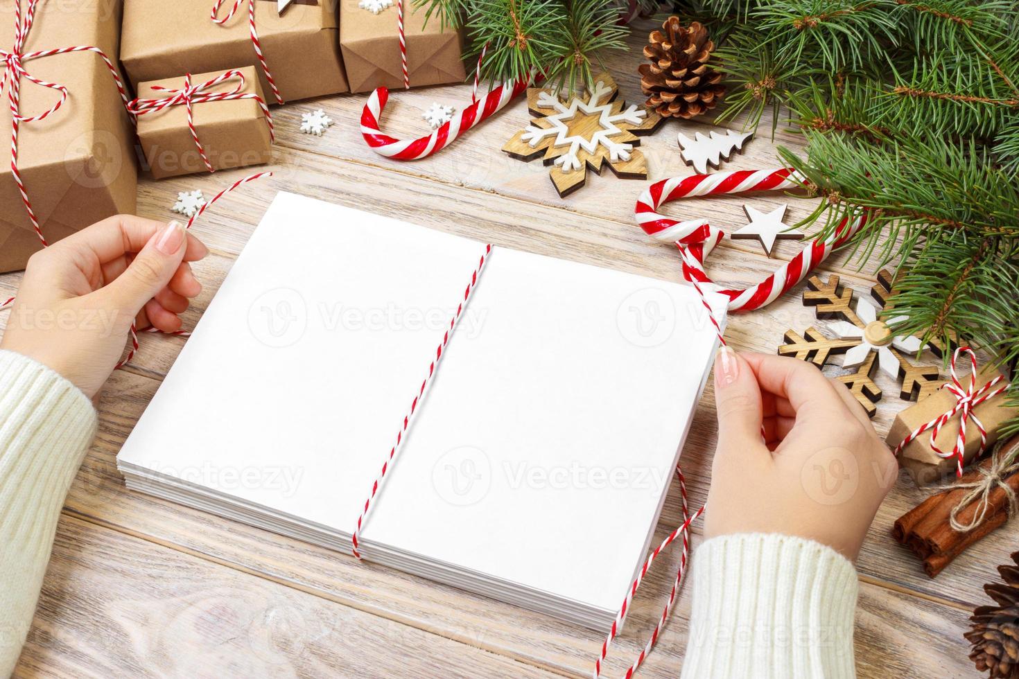 envoltura de cartas y caja de regalo, tarjetas para felicitaciones navideñas. sobres con cartas, regalos, ramas de árboles de navidad y decoración navideña, vista superior, espacio de copia foto