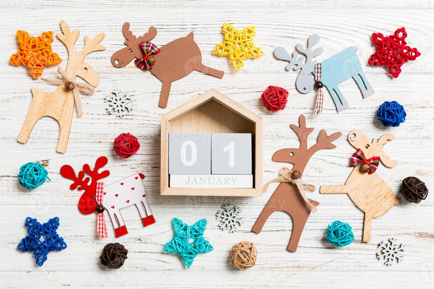Top view of calendar on Christmas wooden background. The first of January. New Year toys and decorations. Holiday concept photo