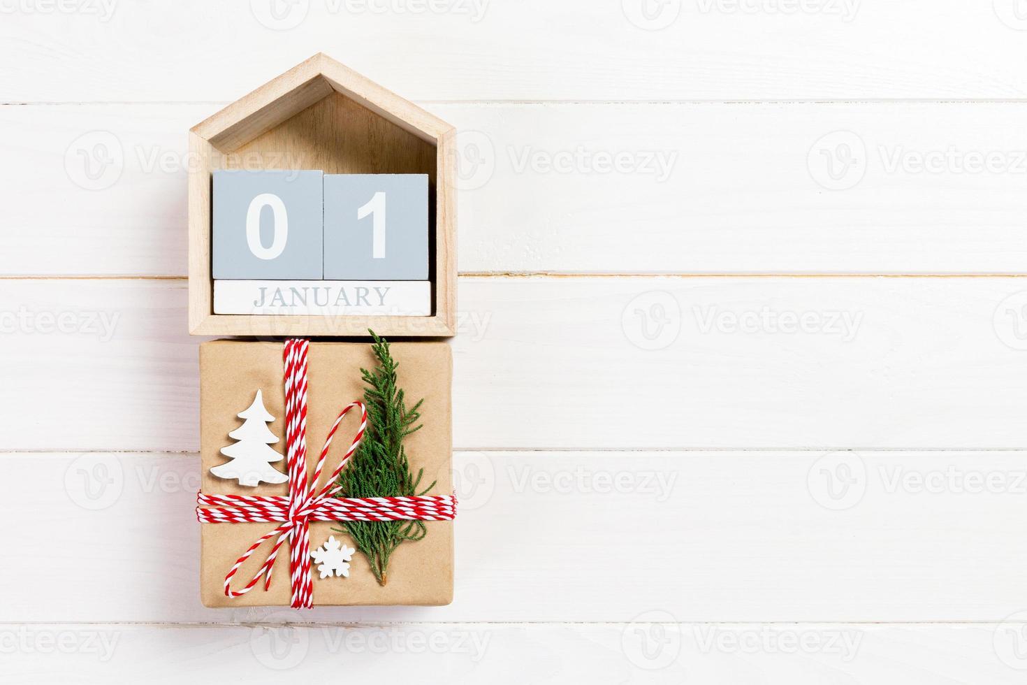 Calendar with date 1 january and gift boxes on color background. Christmas concept photo