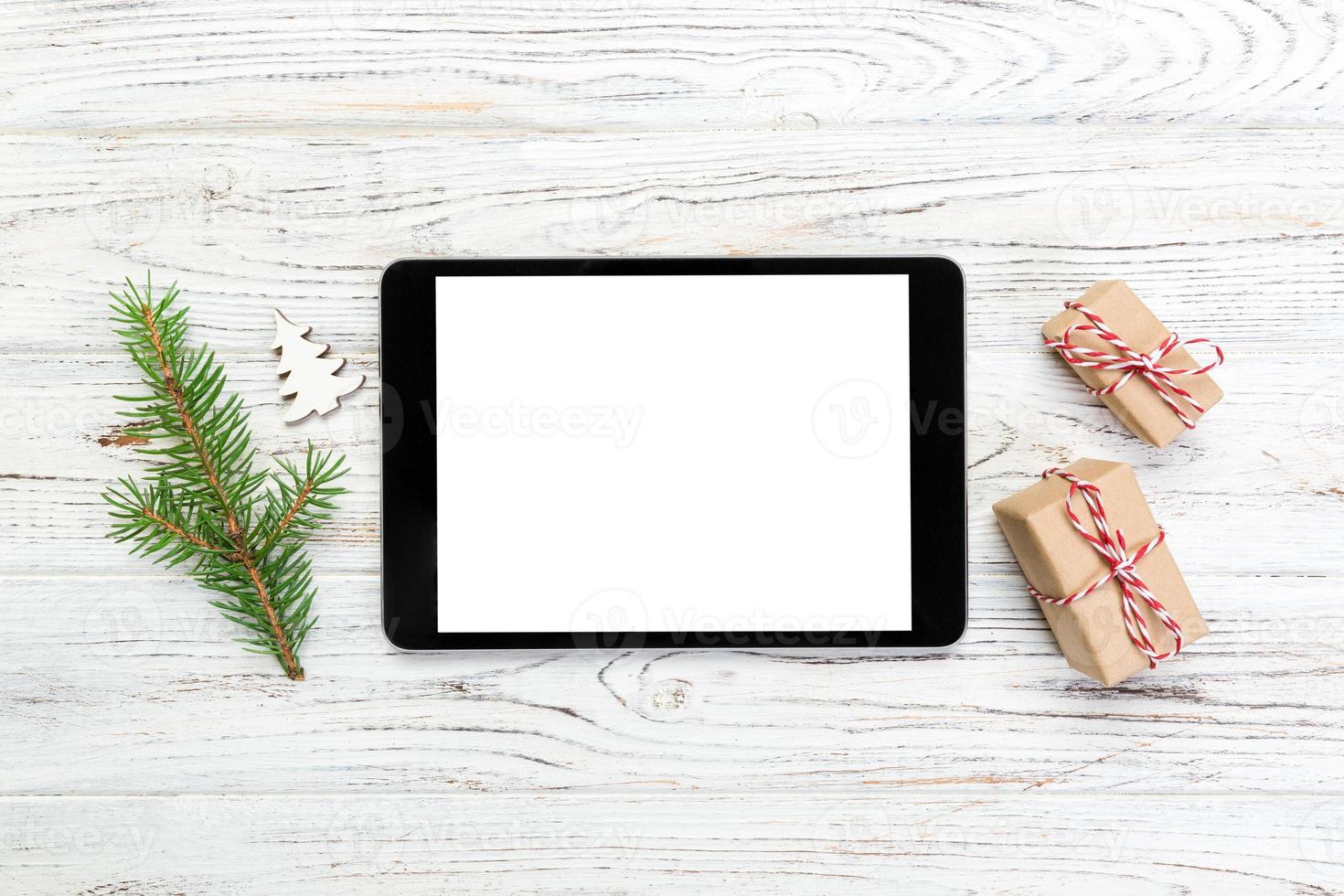 Digital tablet mock up with rustic Christmas wooden background decorations for app presentation. top view with copy space photo