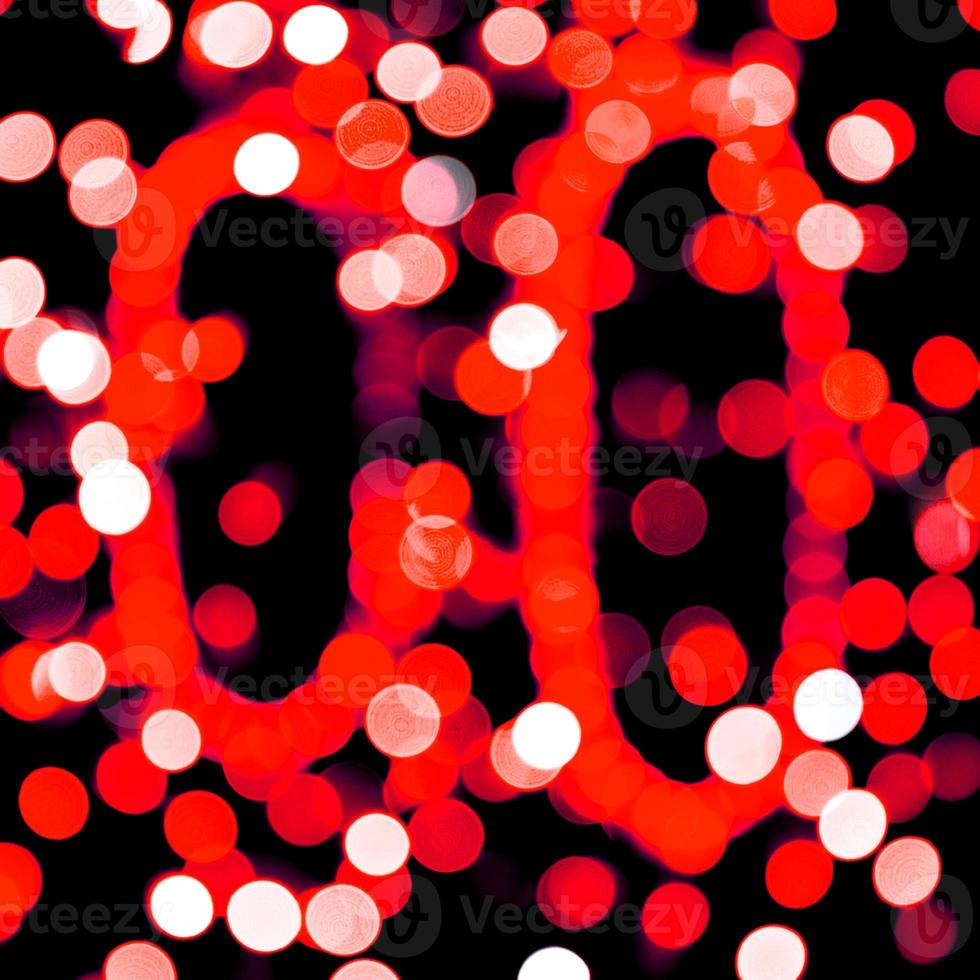 Unfocused abstract red bokeh on black background. defocused and blurred many round light photo