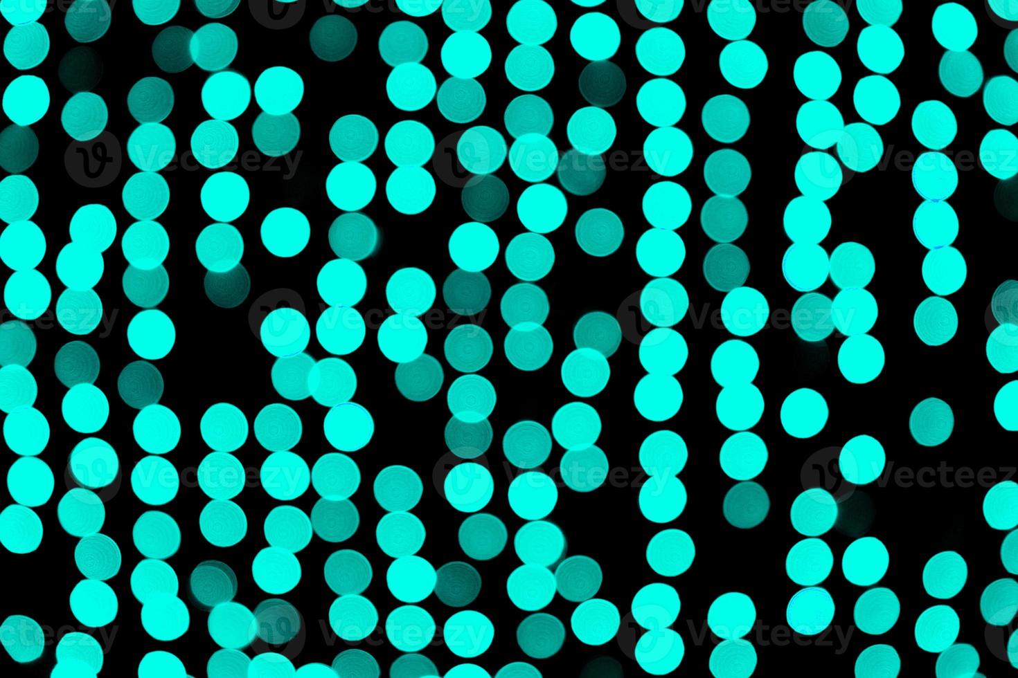 Unfocused abstract colourful bokeh black background. defocused and blurred many round blue light photo