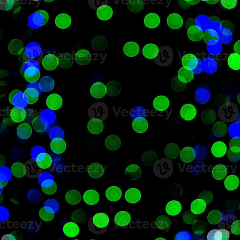 Unfocused abstract colourful bokeh on black background. defocused and blurred many round light photo