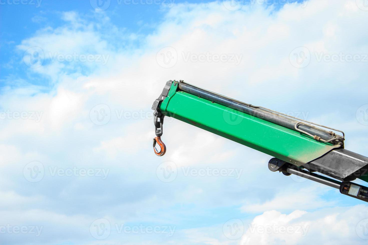 Part of the truck crane. Crane hook against the sky. photo