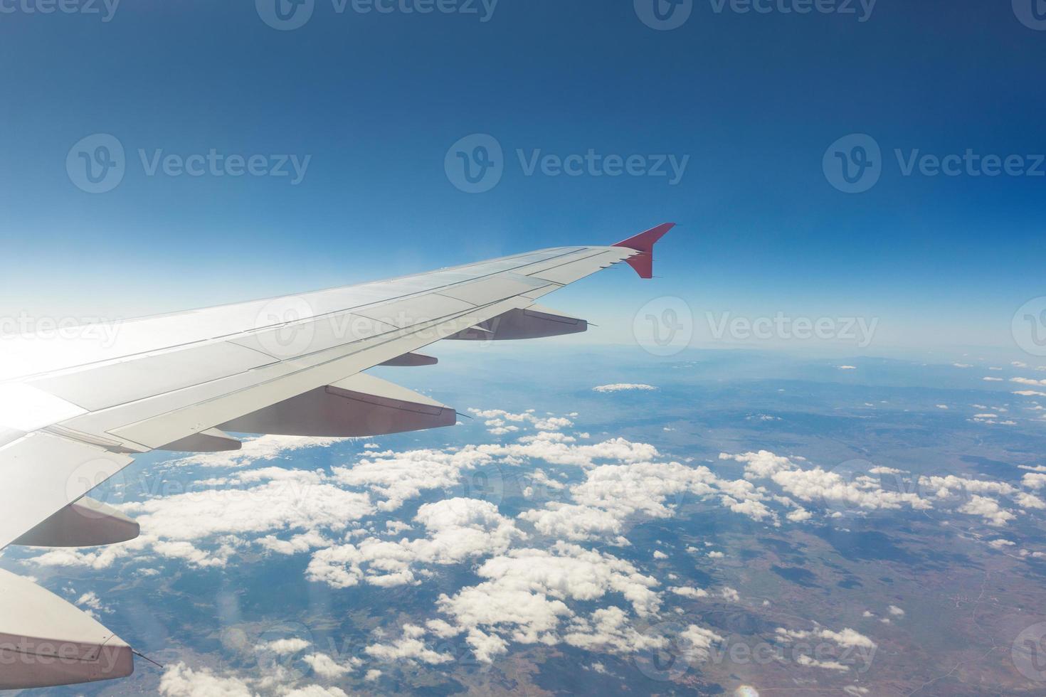 Wing of an airplane. Traveling concept. Aircraft wing on the clouds photo