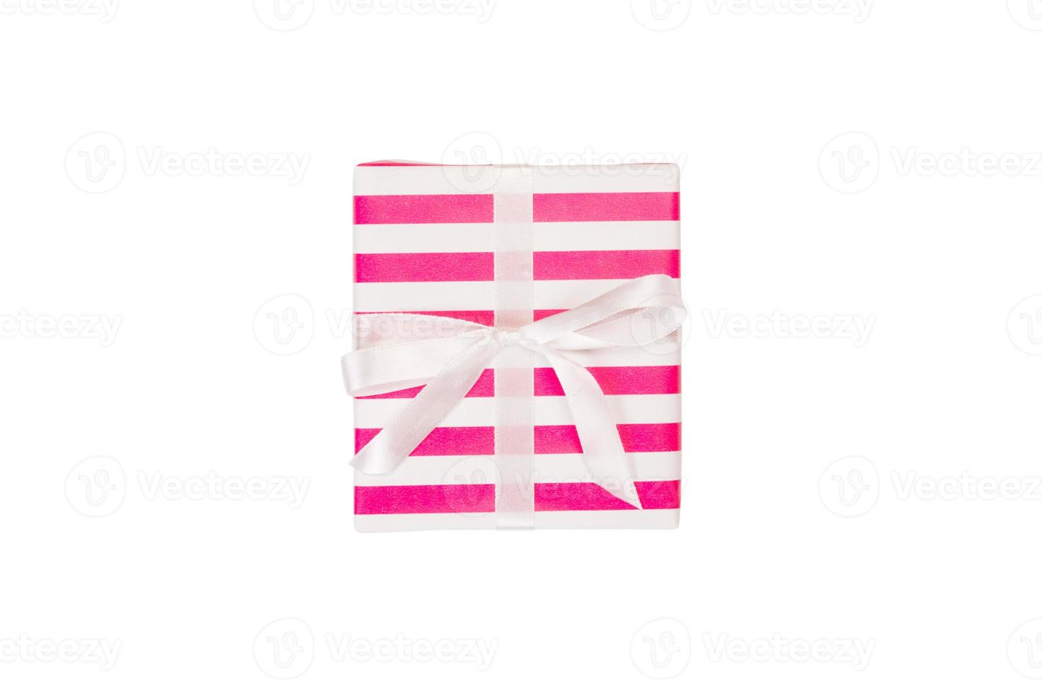 Christmas or other holiday handmade present in pink paper with white ribbon. Isolated on white background, top view. thanksgiving Gift box concept photo