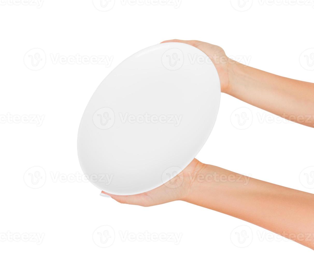 Blank empty round plate in female hand. perspective view, isolated on white background photo