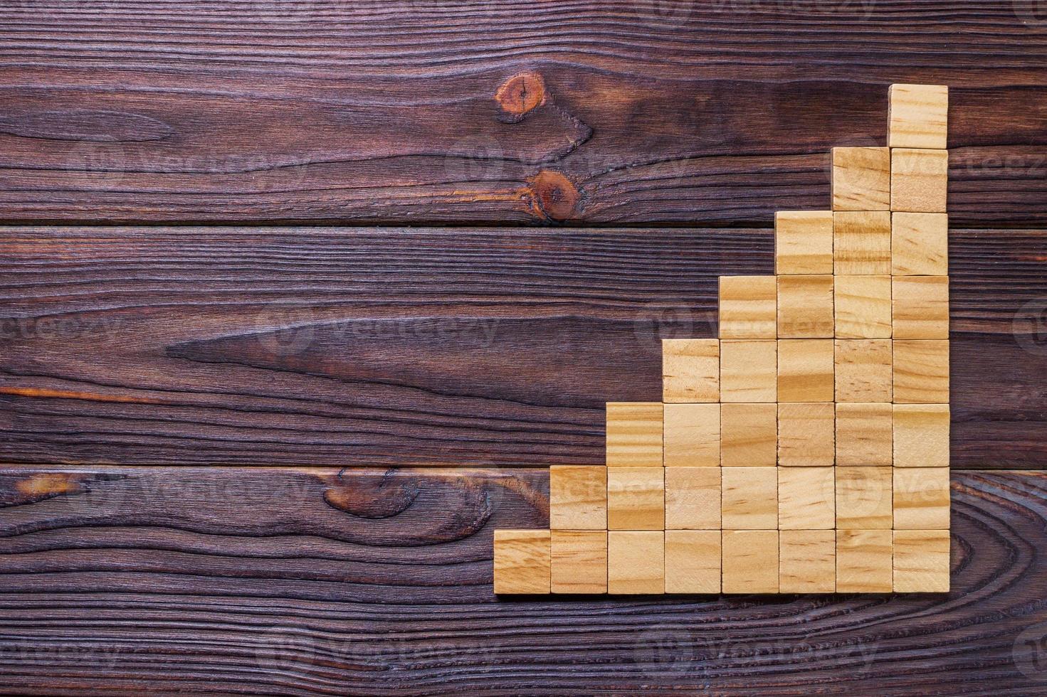 A wooden blocks cube over black wooden textured background with copy space for add word text title. Concept or conceptual Wood block stair or eight steps. Cubic photo