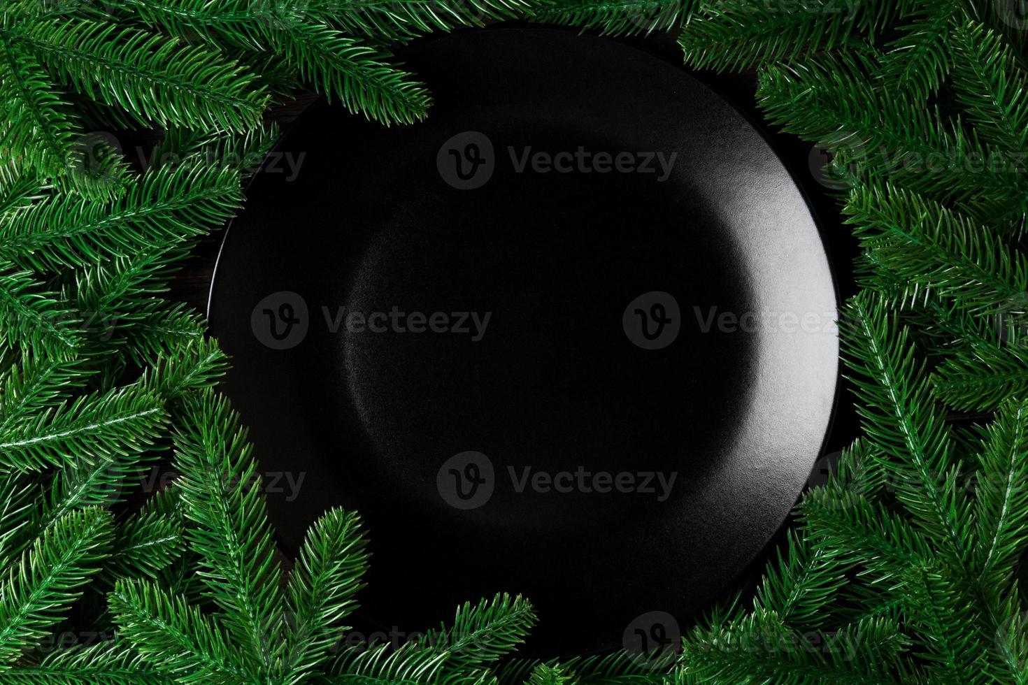 Top view served plate with green fir tree branches. Holiday dinner concept with copy space photo