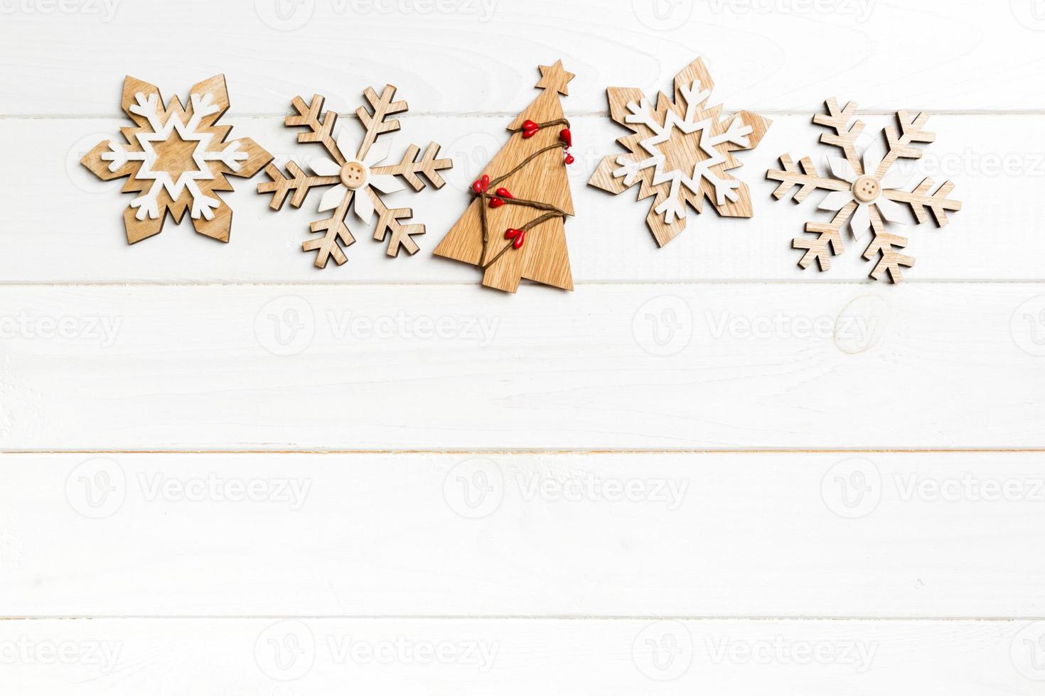 Top view of Christmas decorations and toys on wooden background. New Year holiday concept with empty space for your design photo