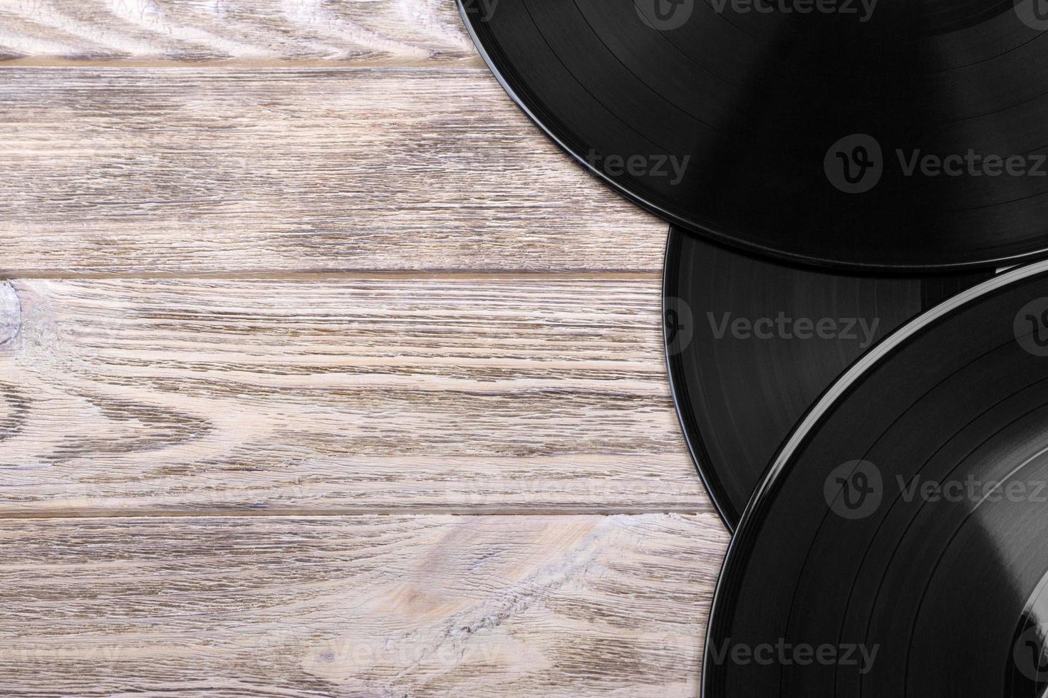 Close up image of old vinyl records over wooden background with copy space photo