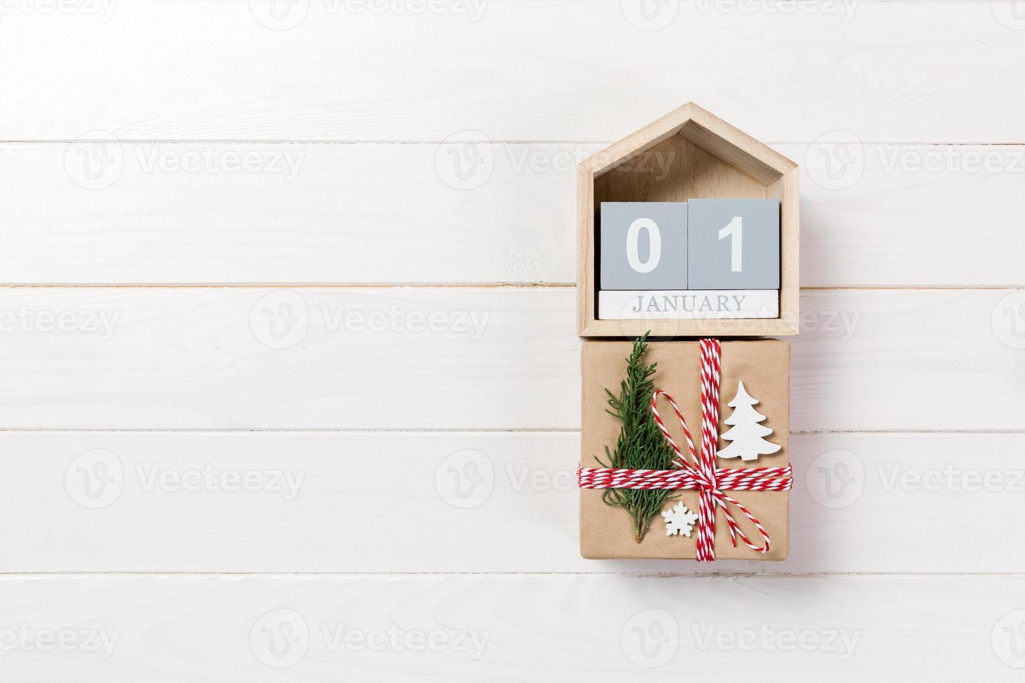 Calendar with date 1 january and gift boxes on color background. Christmas concept photo