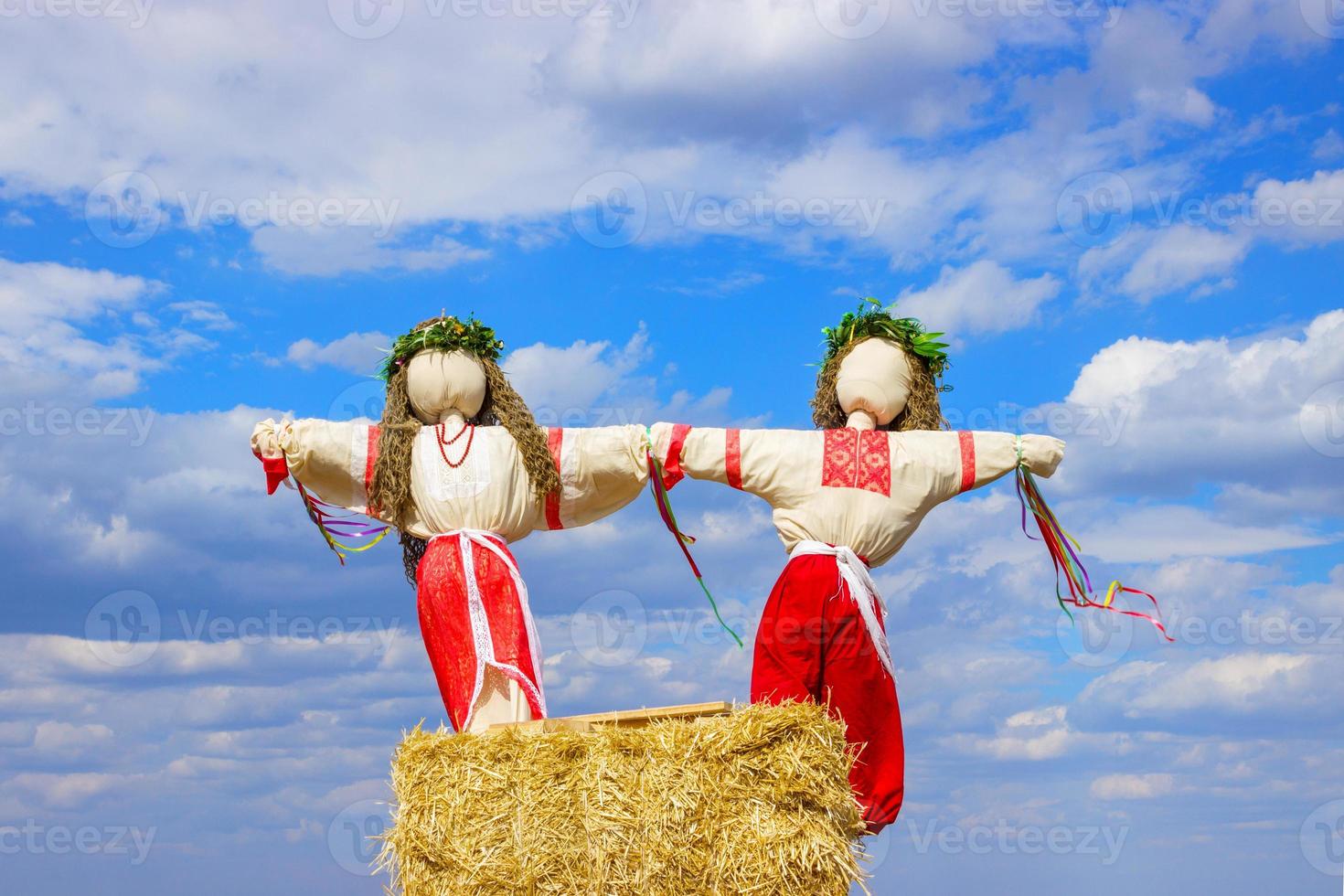 Closeup scarecrow in countryside of Ukraine. Scarecrow against the sky photo