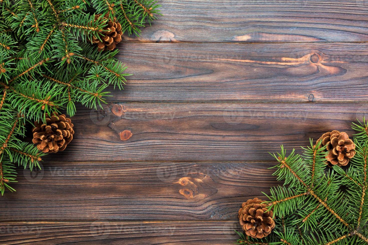 Christmas gray wooden background with fir tree frame and cones copy space. top view empty space for your design photo