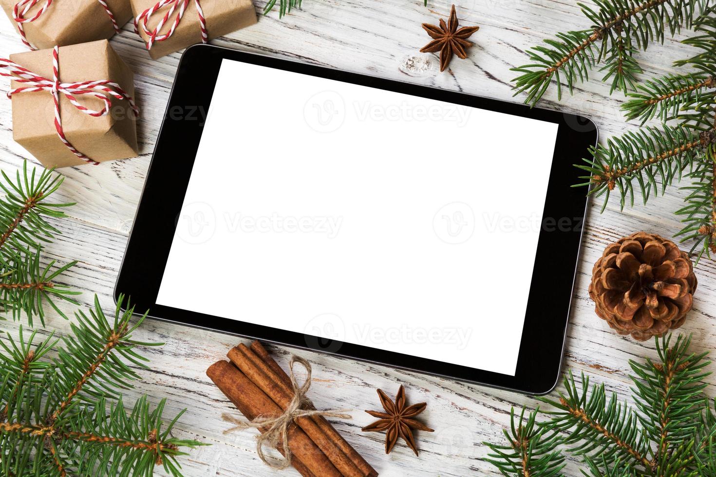 Digital tablet mock up with rustic Christmas wooden background decorations for app presentation. top view with copy space photo