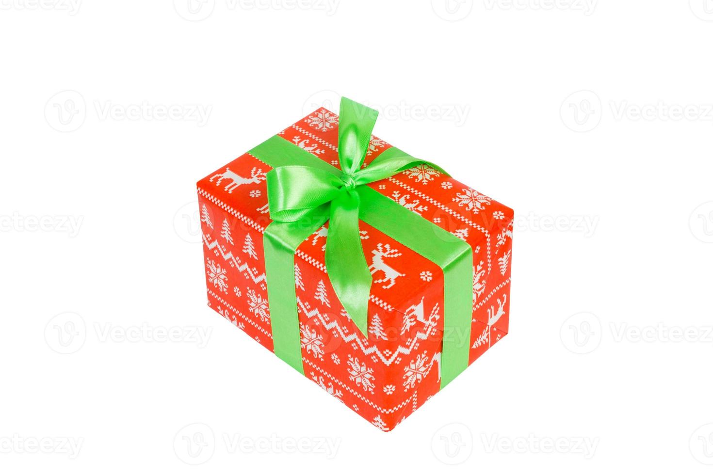 Christmas or other holiday handmade present in red paper with green ribbon. Isolated on white background, top view. thanksgiving Gift box concept photo