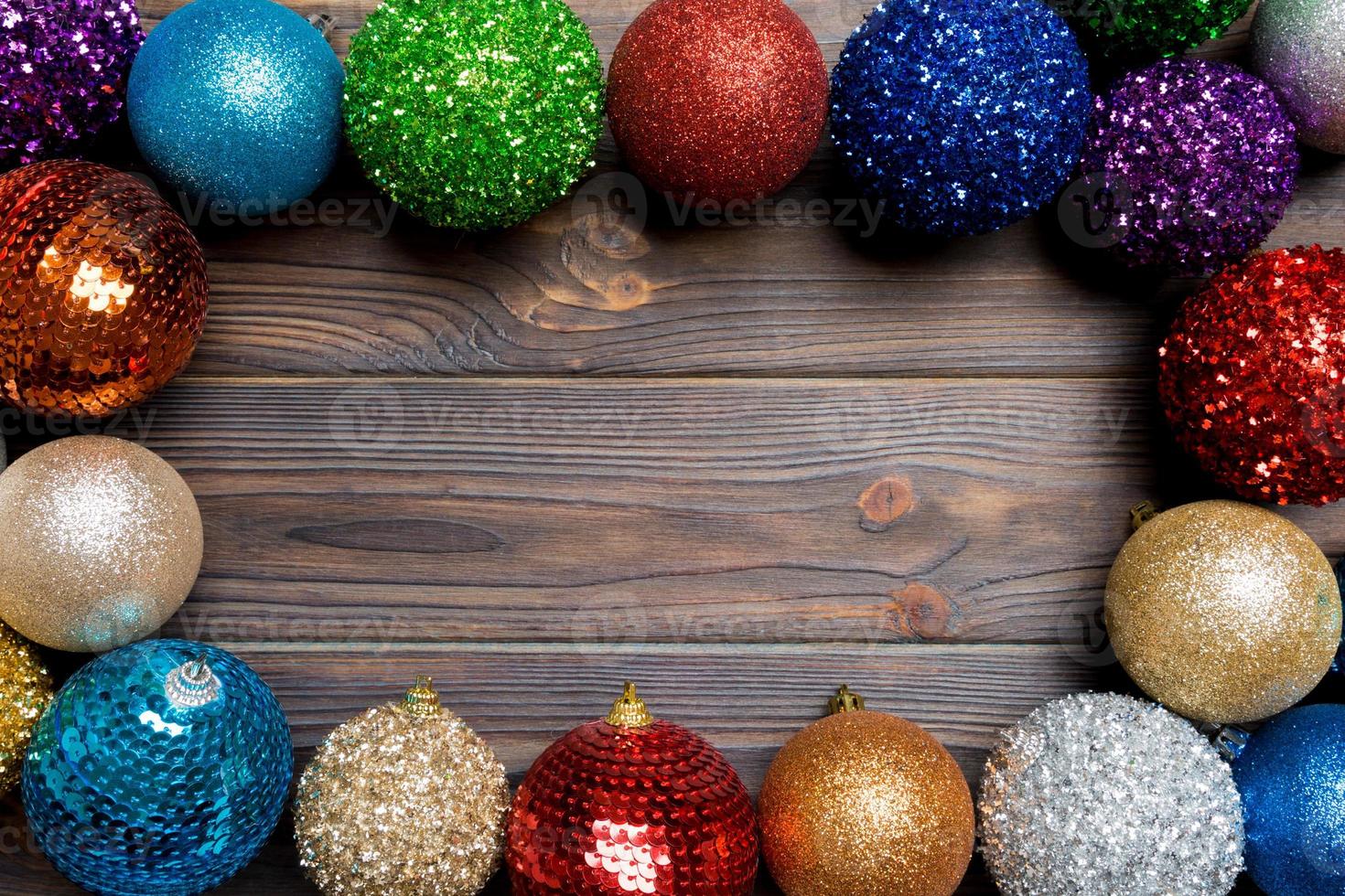 Festive composition of decorative baubles on wooden background. Top view of Christmas toys with copy space photo