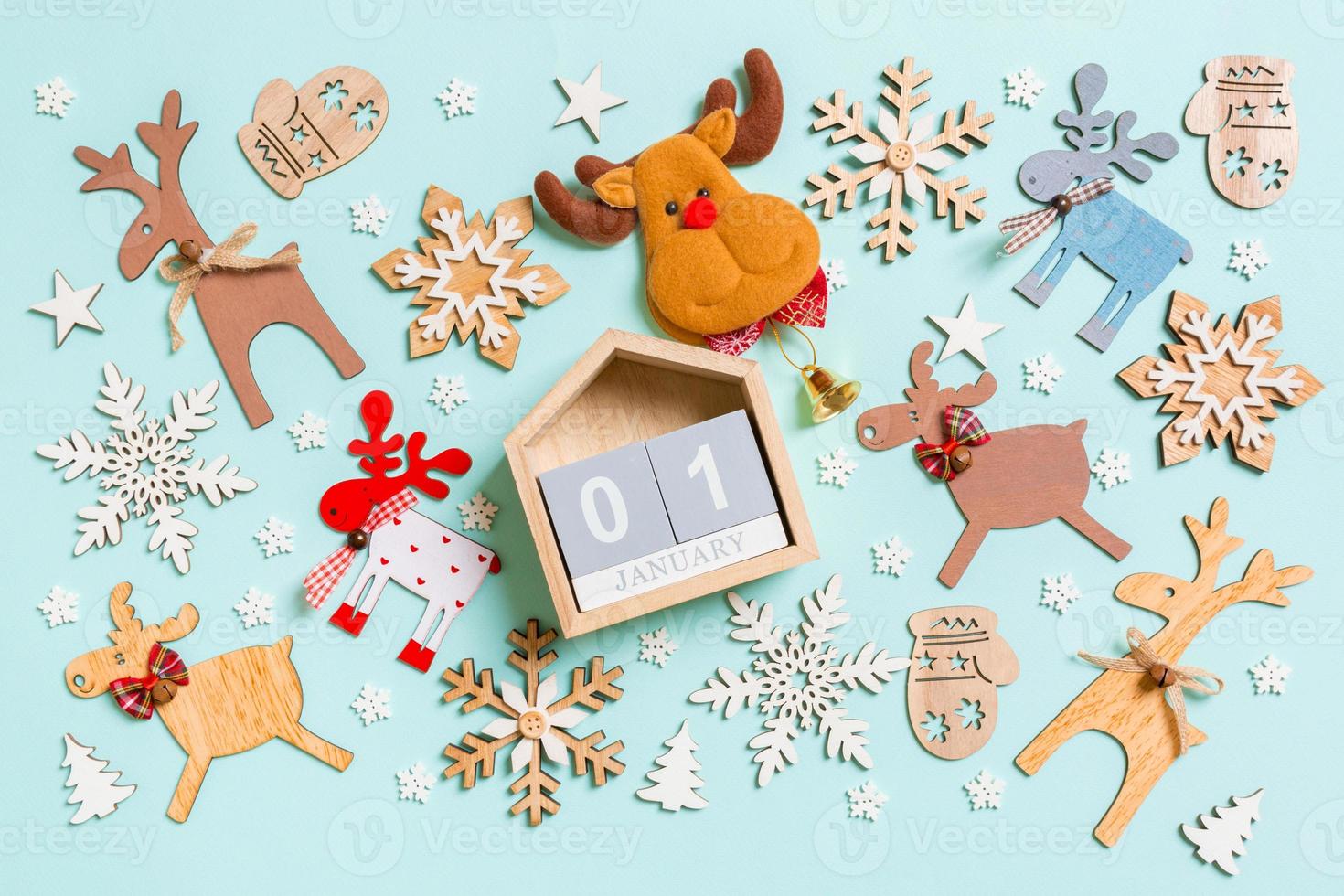 Top view of calendar on blue background made of holiday decorations and toys. Christmas ornament concept photo