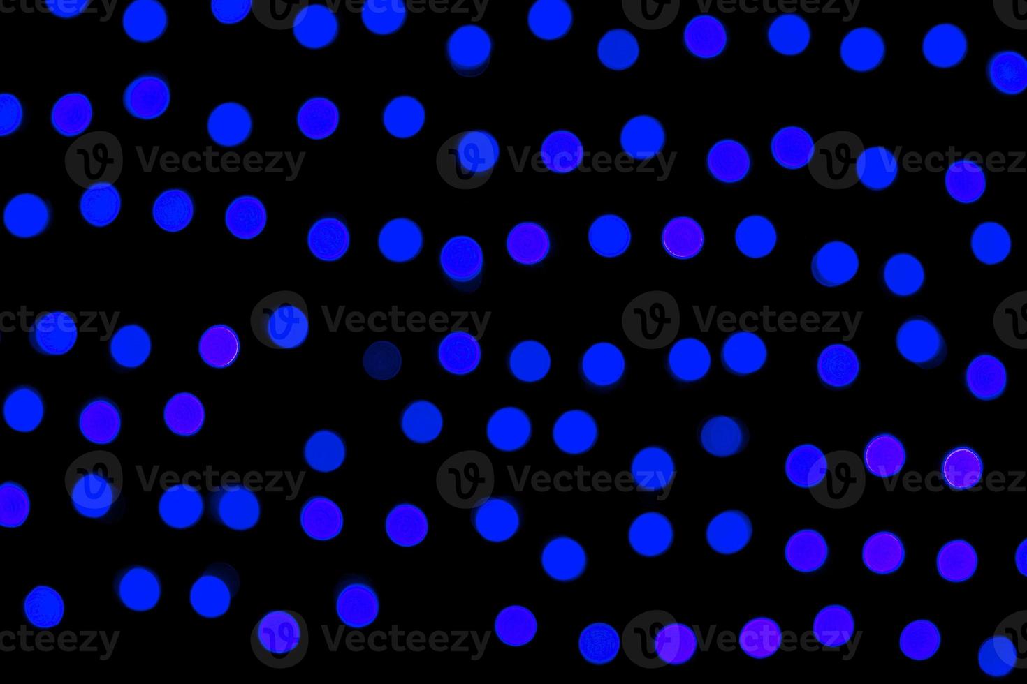 Unfocused abstract dark blue bokeh on black background. defocused and blurred many round light photo