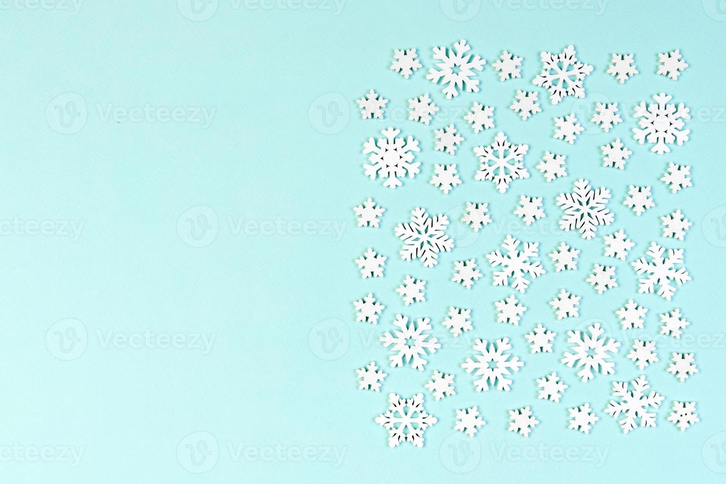 Top view of white snowflakes on colorful background. Winter weather concept with copy space. Merry Christmas concept photo