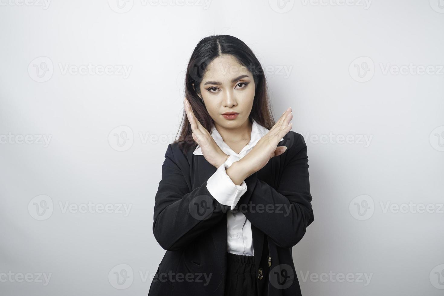 Beautiful Asian woman wearing black suit with hand gesture pose rejection or prohibition with copy space photo