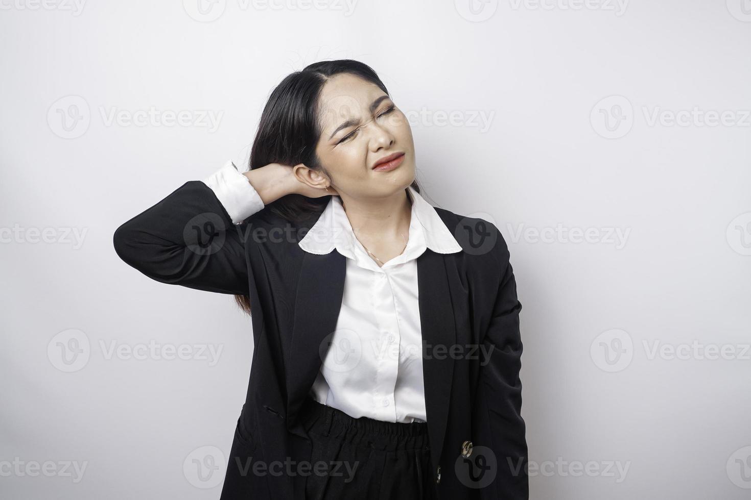 Tired upset young business woman suffering from pain, muscle spasm at workplace. Fatigue, deadline, pain and incorrect posture photo