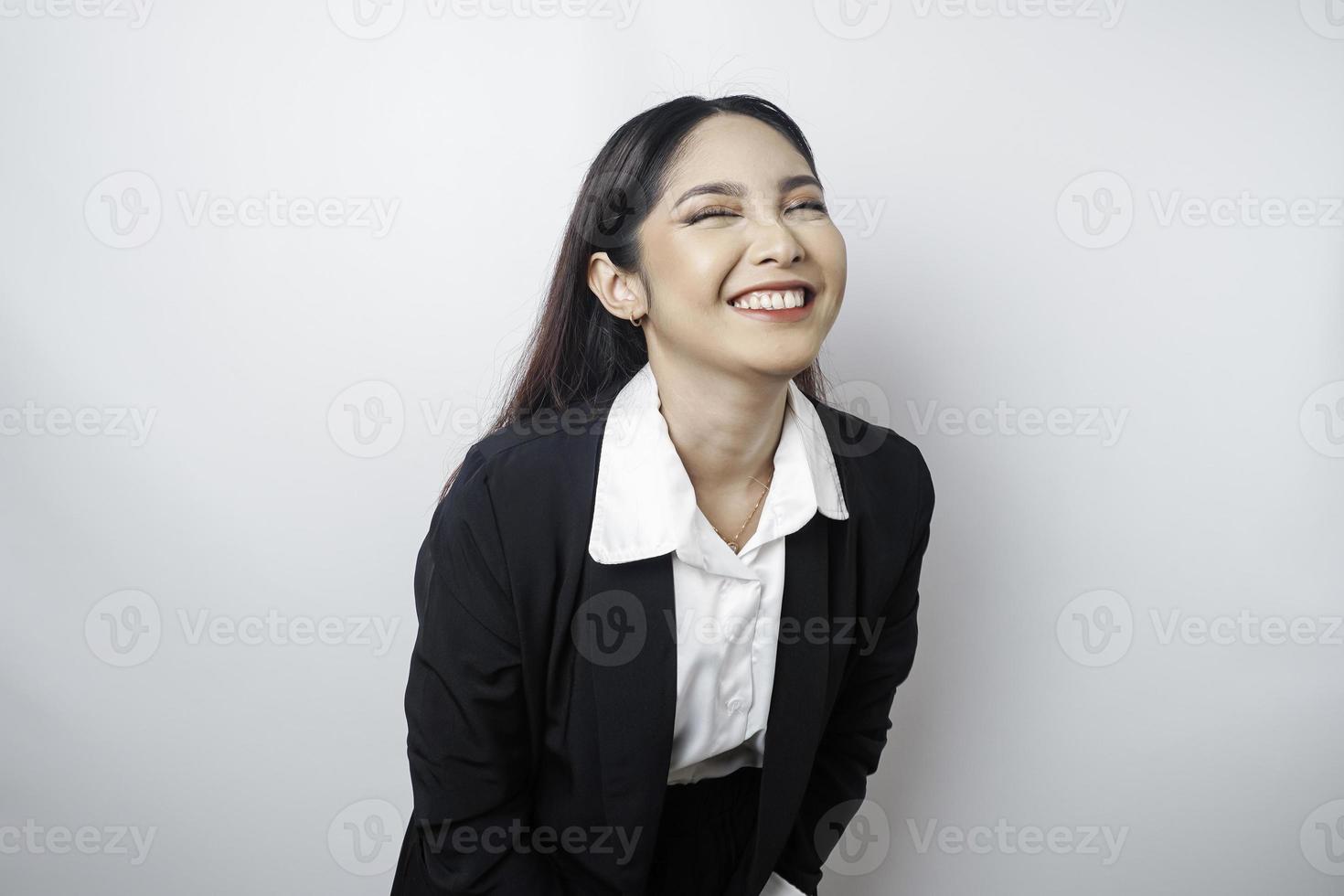 A portrait of a happy Asian woman wearing a black suit isolated by a white background photo