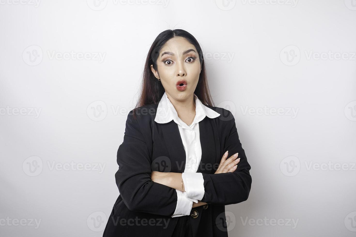 A portrait of a shocked Asian woman wearing a black suit, isolated by a white background photo