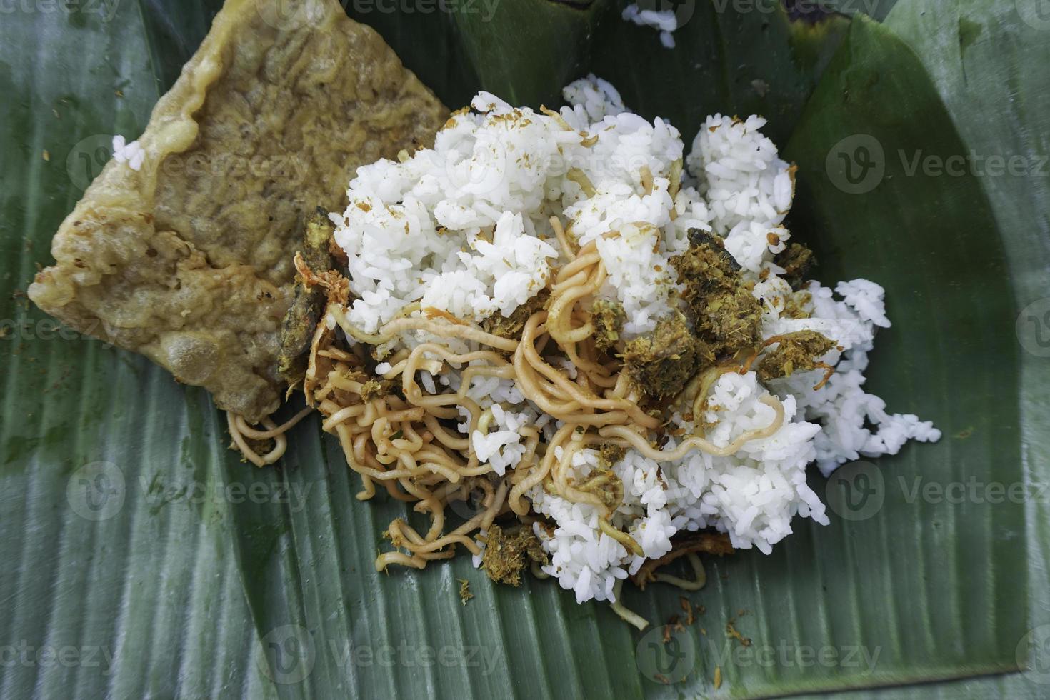 A portrait of Balinese food called Nasi Jinggo on banana leaf photo