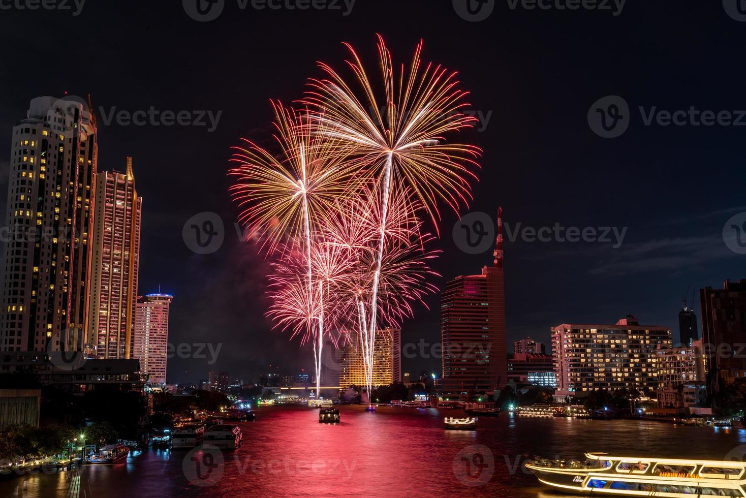fireworks celebration on the river in the dark sky photo