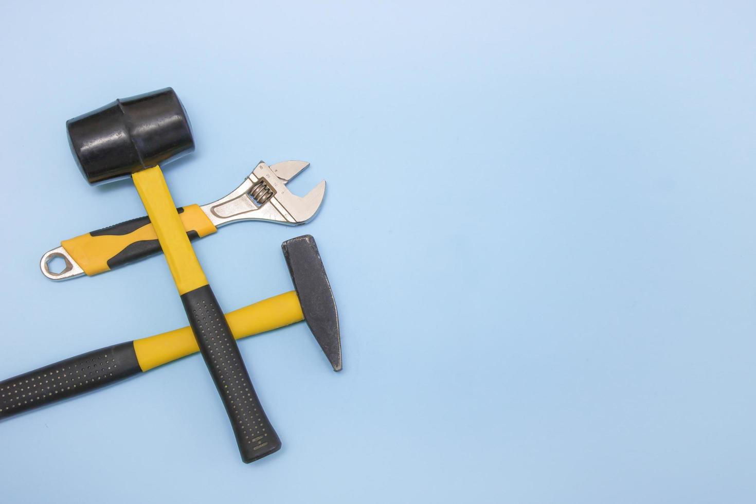hammer, mallet, sanitary key on a light blue background with copy space photo