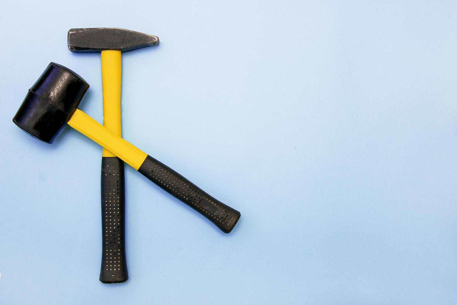 hammer, mallet on a light blue background with copy space photo