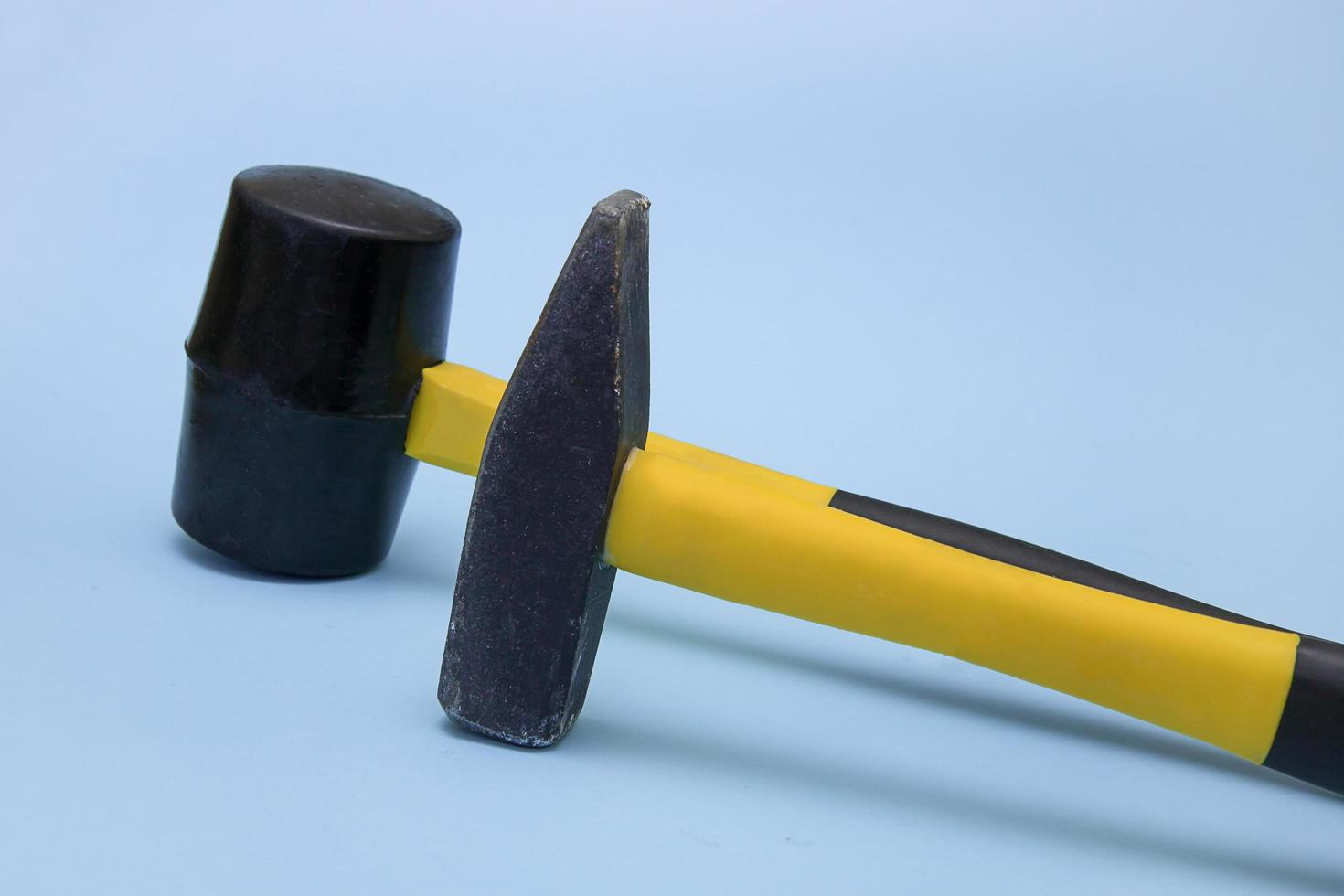 hammer and mallet on a light blue background, the concept of construction, tools, repair, brutality photo