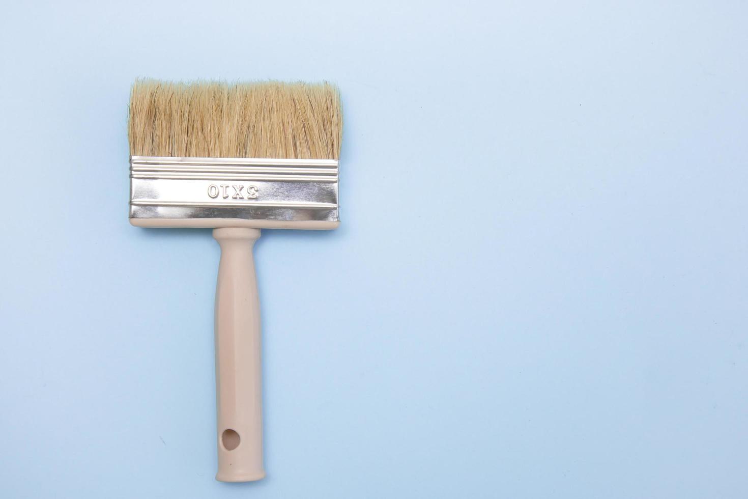 paint brush on a light blue background with copy space photo