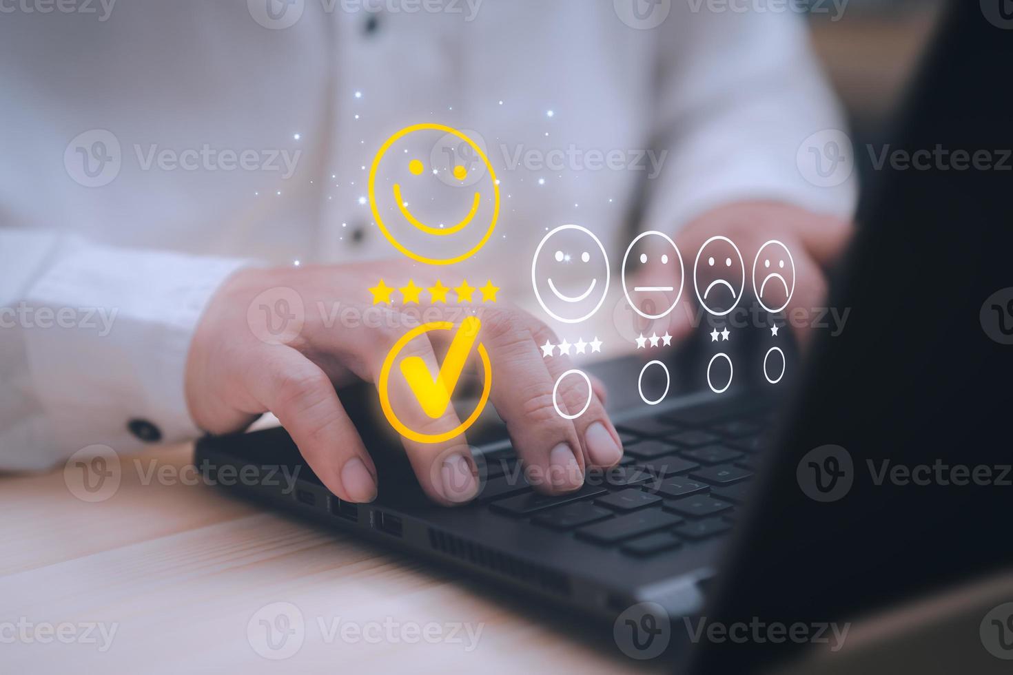 Man hand using computer laptop with popup five star icon for feedback review satisfaction service, testimonial. Customer service experience and business satisfaction survey. photo