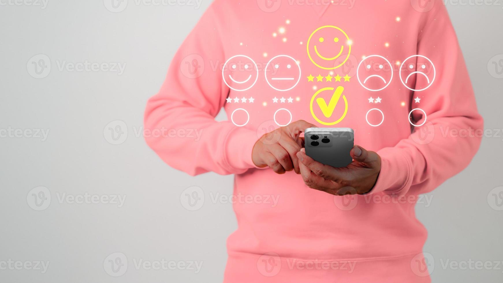 Man using a mobile phone in give rating to service experience on application. Online customer review satisfaction feedback survey and testimonial. photo