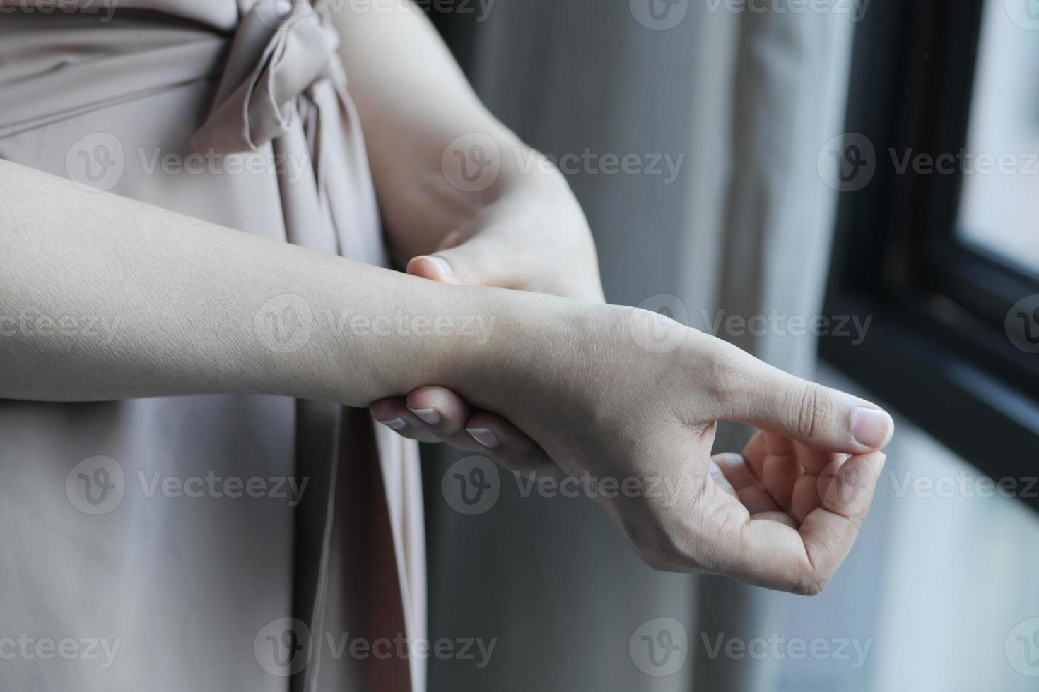 Young women hands suffering wrist pain, photo