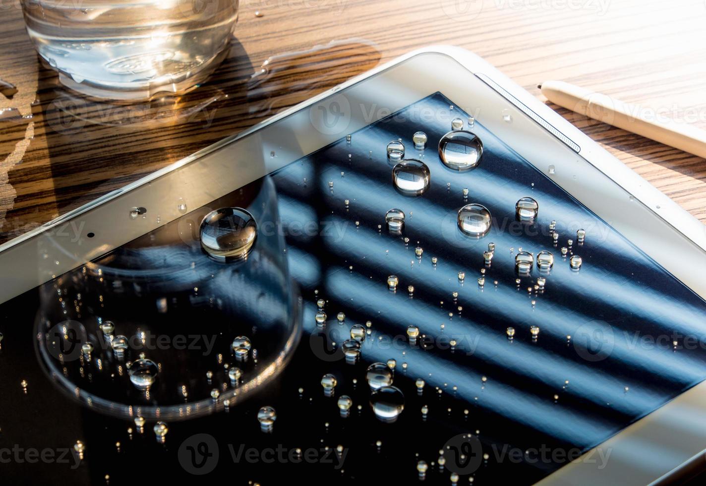 Drops of water on tablet screen photo