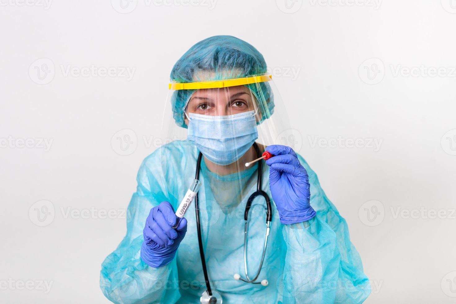 Medical healthcare holding COVID-19 , Coronavirus swab collection kit, wearing PPE protective suit mask gloves, test tube for taking OP NP patient specimen sample,PCR DNA testing protocol process photo