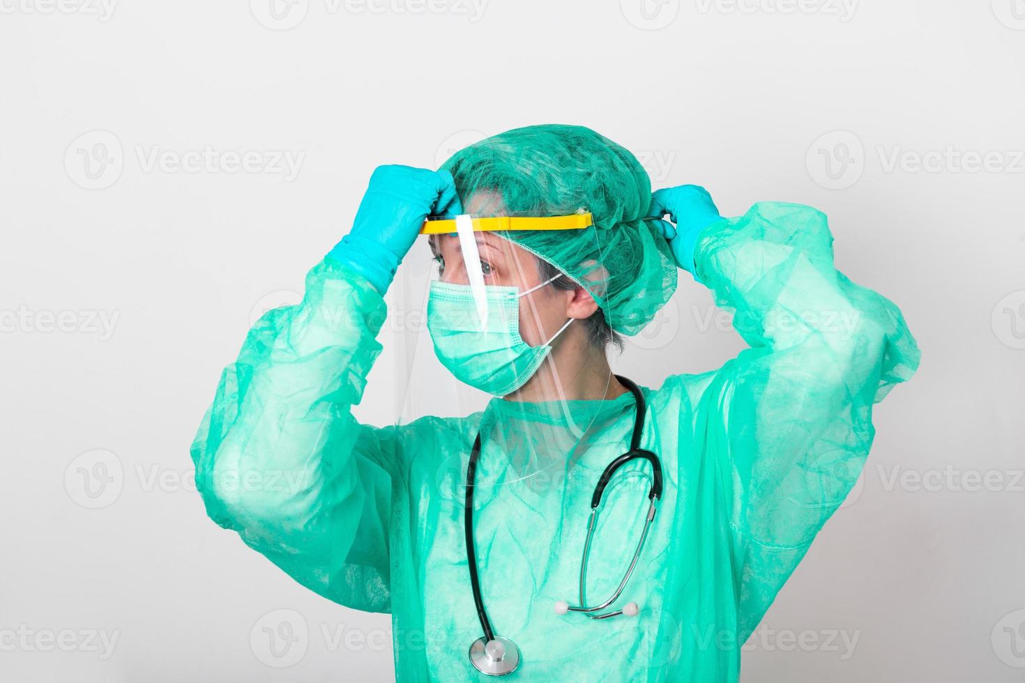 Concept of coronavirus quarantine. Covid  19. Novel coronavirus  2019-nCoV .Doctor with a stethoscope Tear the paper with the word coronavirus. photo