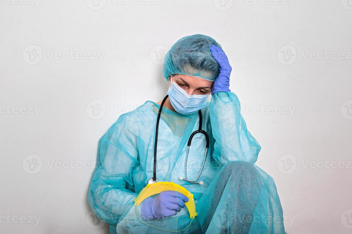 Coronavirus pandemic . Tired exhausted doctor, nurse after long shift fighting against Coronavirus 2019-nCoV at hospital clinic. Global pandemic outbreak Coronavirus -CoVid-19 worldwide virus. photo