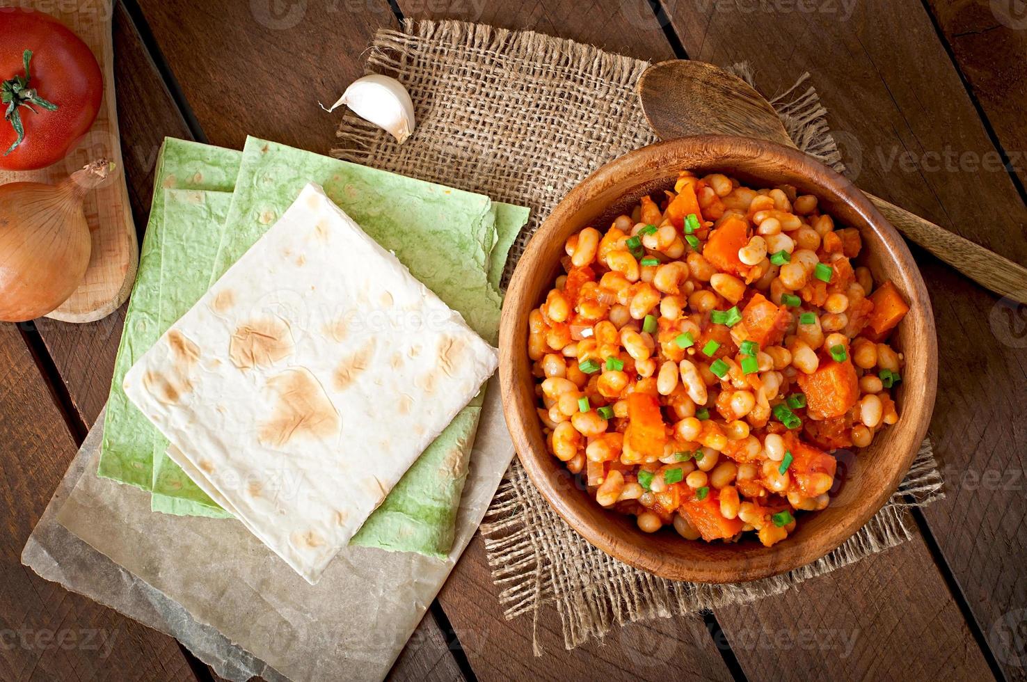 Stewed white beans and sliced pumpkin in tomato sauce photo