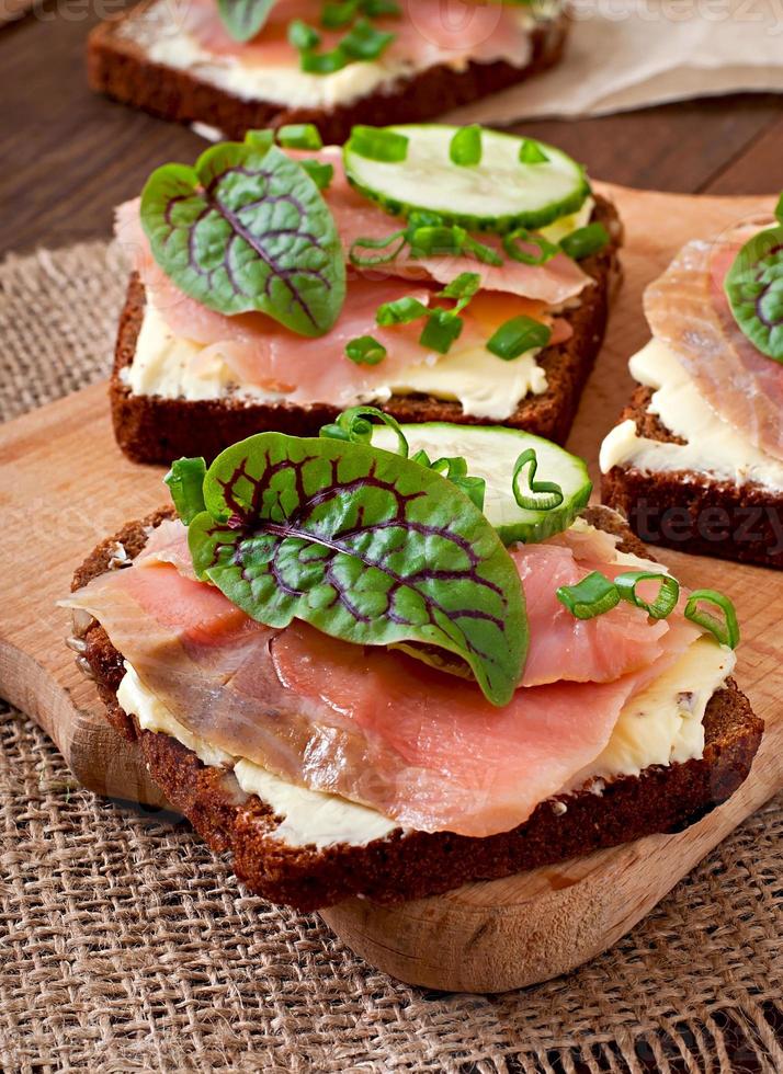 Small snacks sandwiches with salty salmon photo