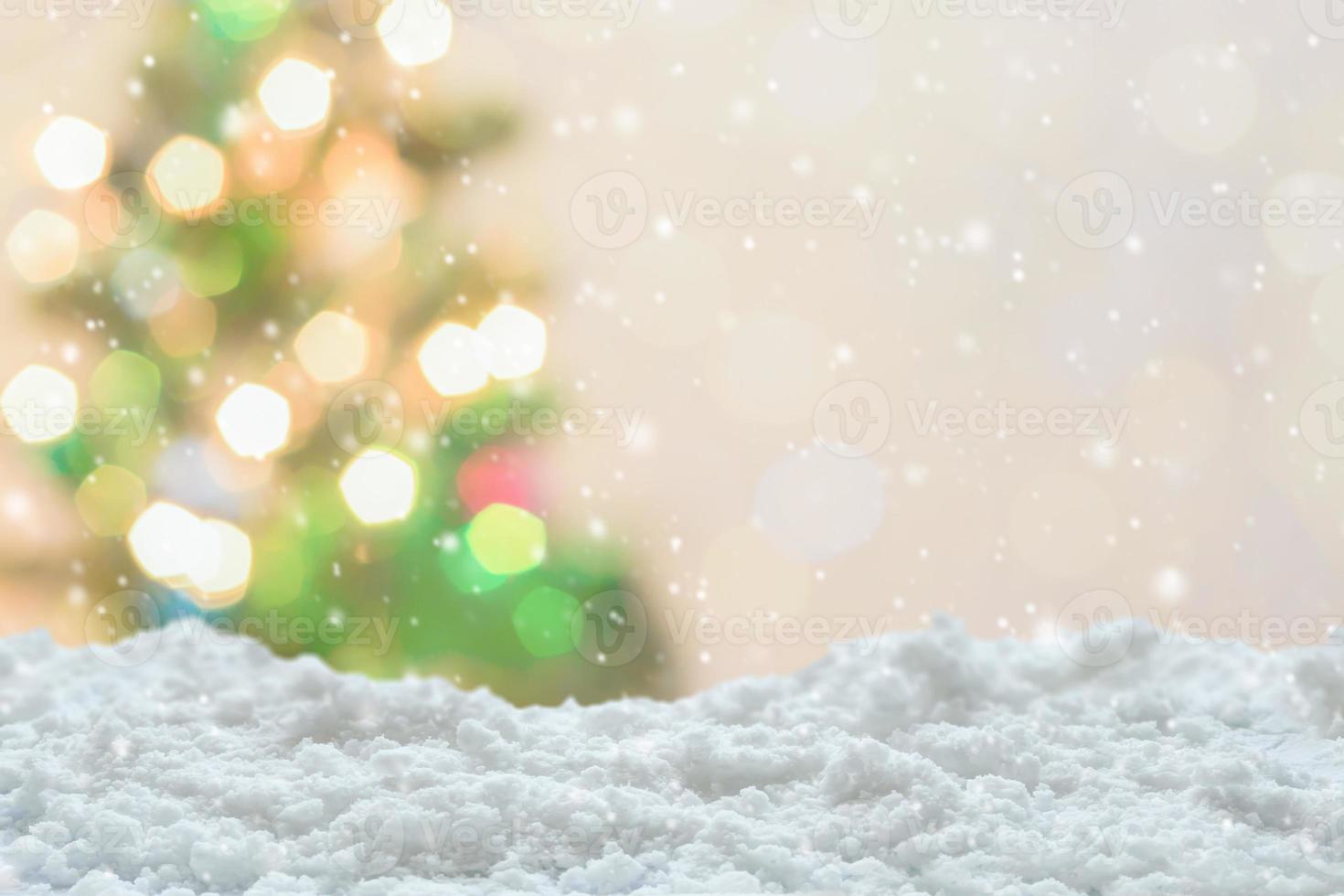 Empty white snow with blur Christmas tree with bokeh light background photo