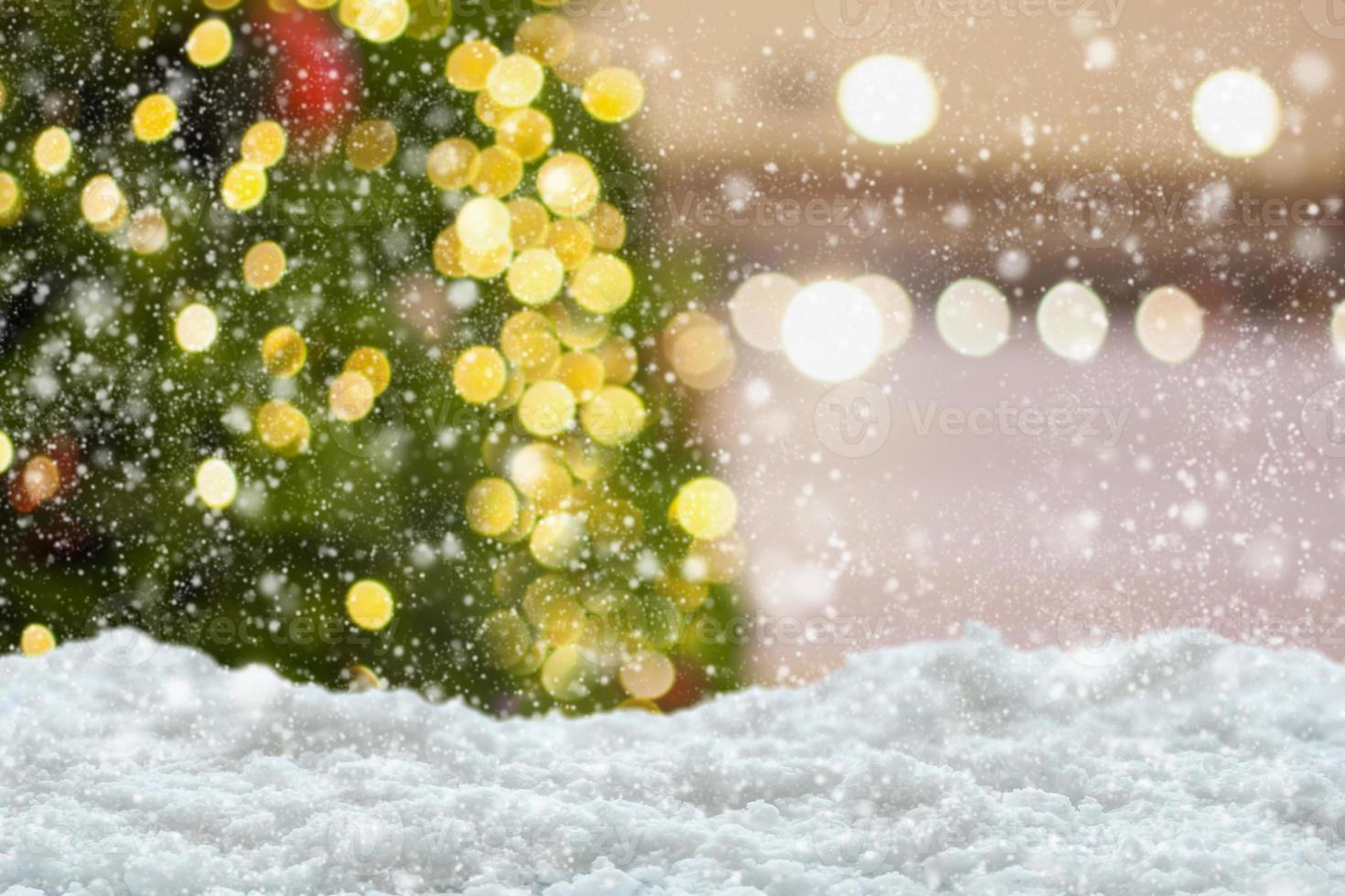 Empty white snow with blur Christmas tree with bokeh light background photo