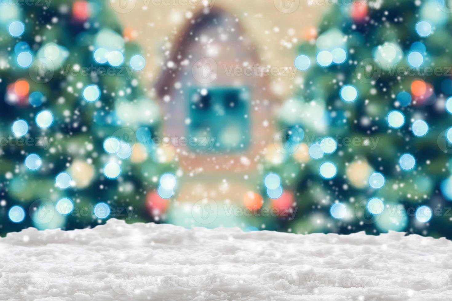 Empty white snow with blur Christmas tree with bokeh light background photo